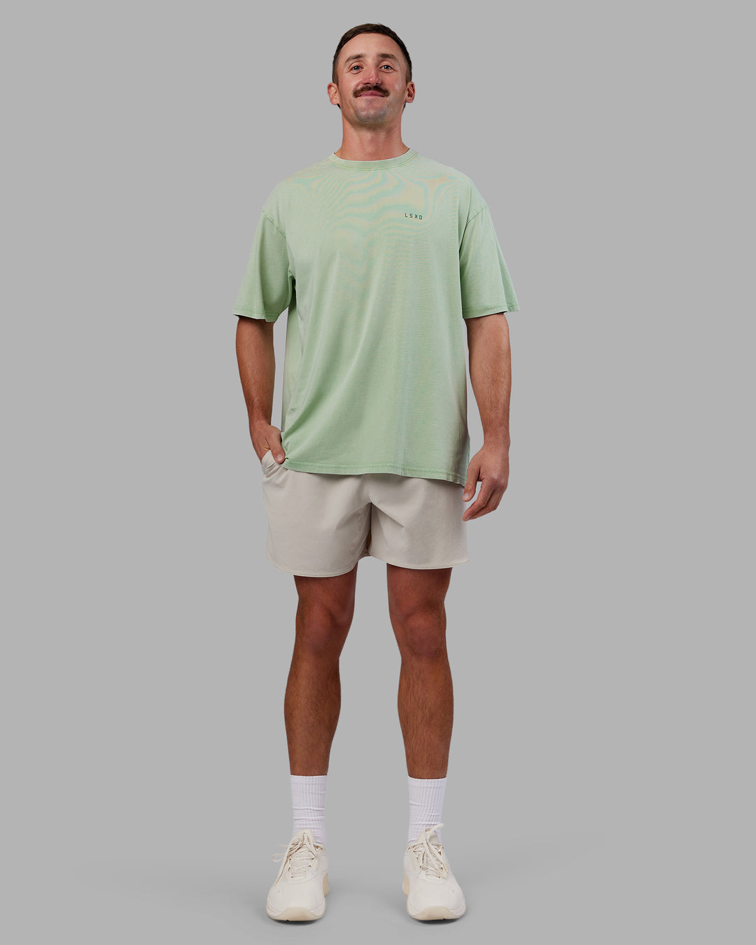 Man wearing Abs Unisex Growth FLXCotton Oversized Tee - Matcha Green Washed | Model:Fletcher | Size:L