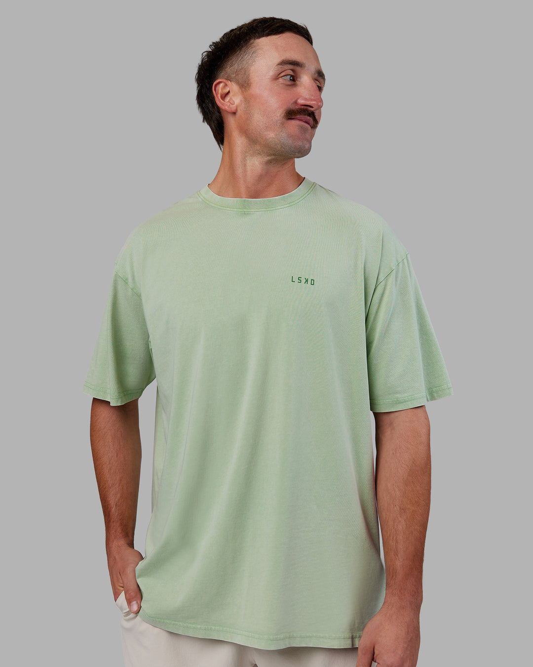 Man wearing Abs Unisex Growth FLXCotton Oversized Tee - Matcha Green Washed | Model:Fletcher | Size:L
