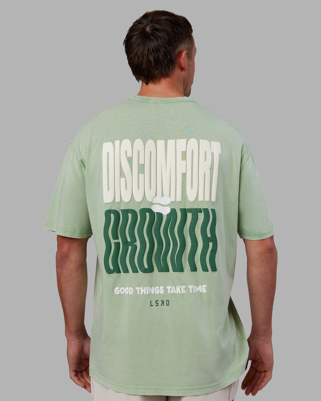 Man wearing Abs Unisex Growth FLXCotton Oversized Tee - Matcha Green Washed | Model:Fletcher | Size:L