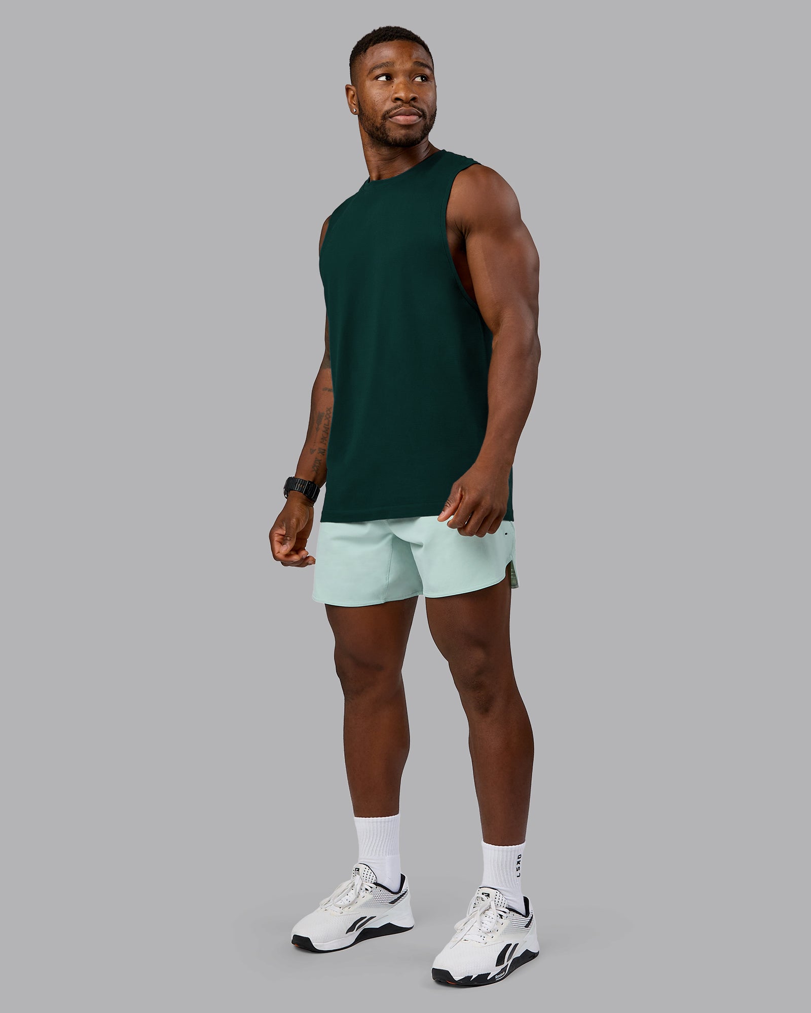 Man wearing AeroFLX+ Seamless Muscle Tank - Dark Moss/Dark Moss Marl | Model:Sam | Size:L