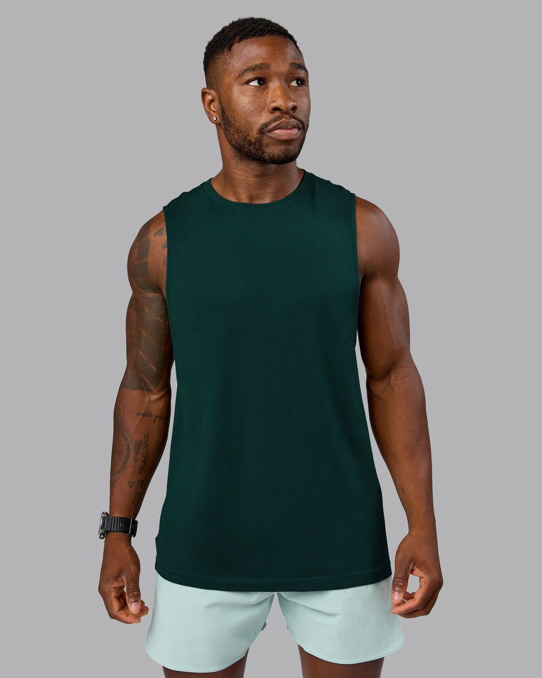 Man wearing AeroFLX+ Seamless Muscle Tank - Dark Moss/Dark Moss Marl | Model:Sam | Size:L
