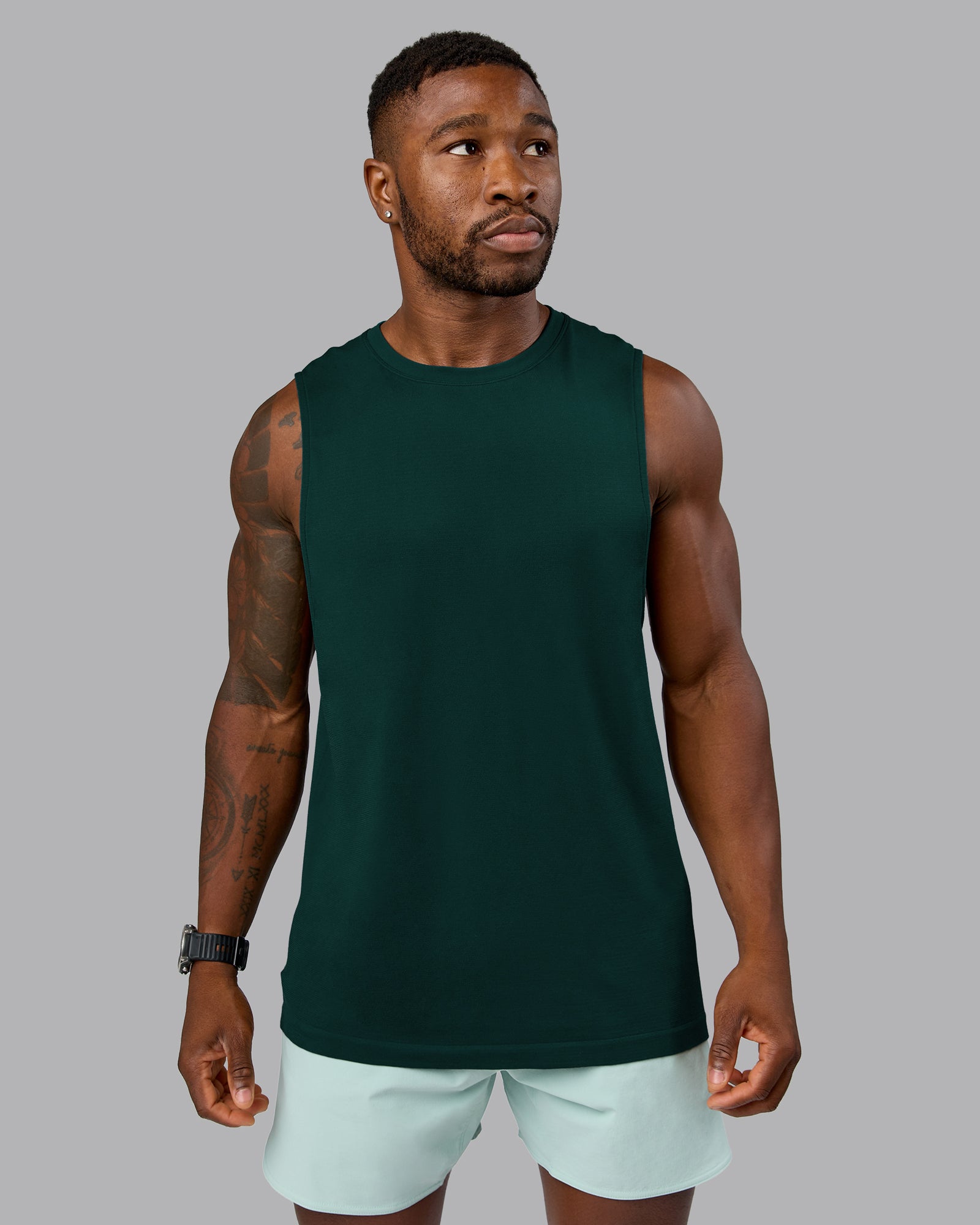 Man wearing AeroFLX+ Seamless Muscle Tank - Dark Moss/Dark Moss Marl | Model:Sam | Size:L