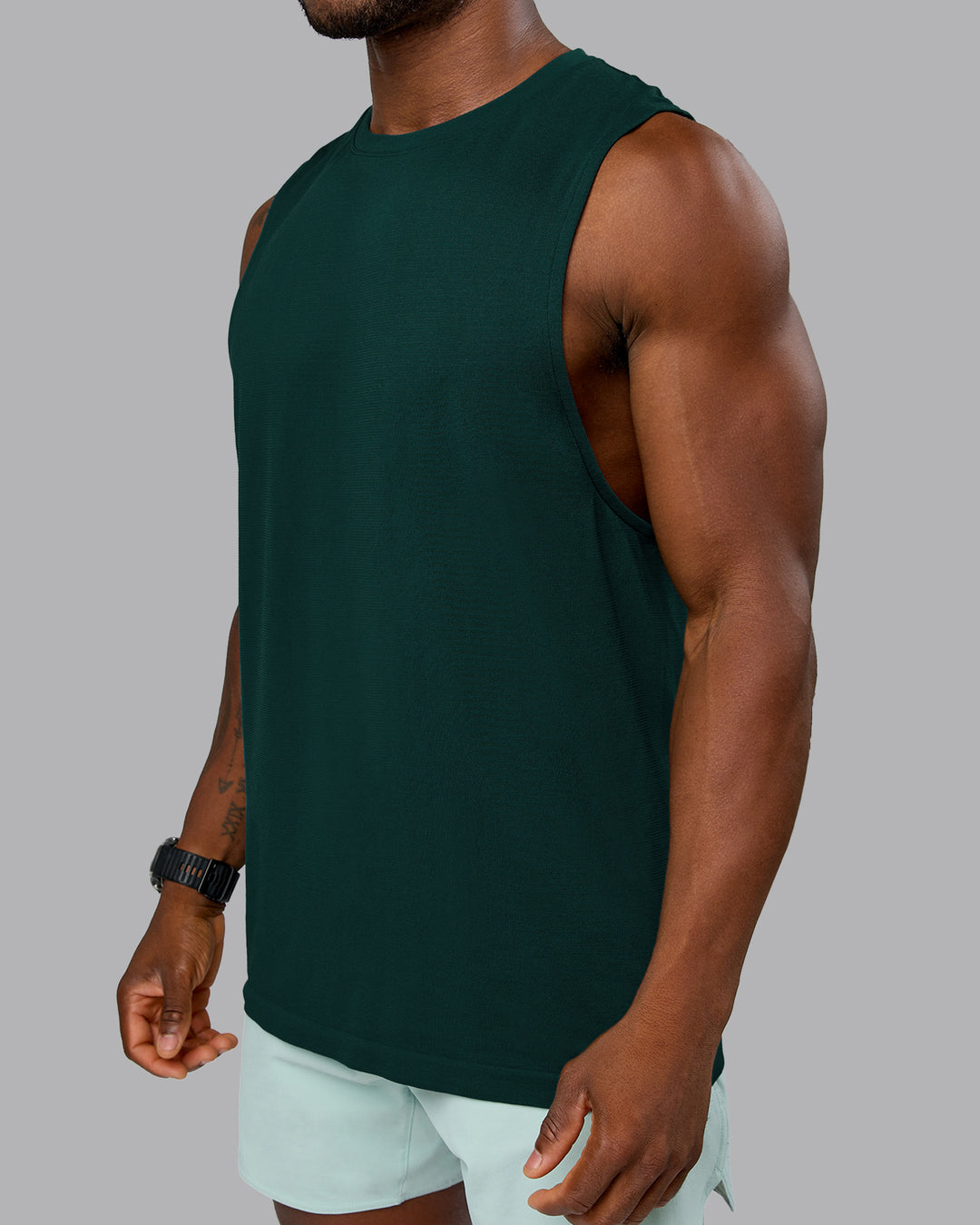 Man wearing AeroFLX+ Seamless Muscle Tank - Dark Moss/Dark Moss Marl | Model:Sam | Size:L