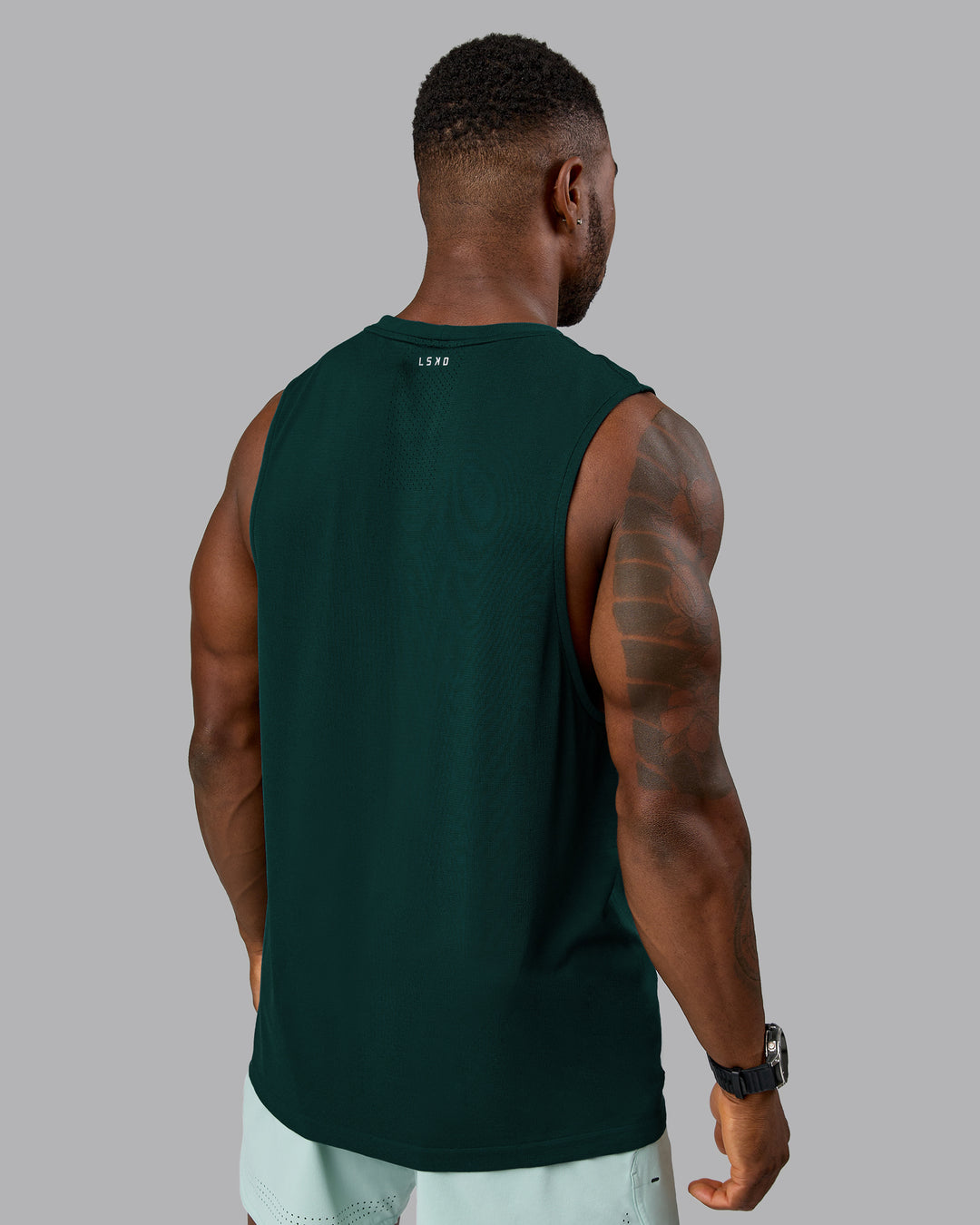 Man wearing AeroFLX+ Seamless Muscle Tank - Dark Moss/Dark Moss Marl | Model:Sam | Size:L