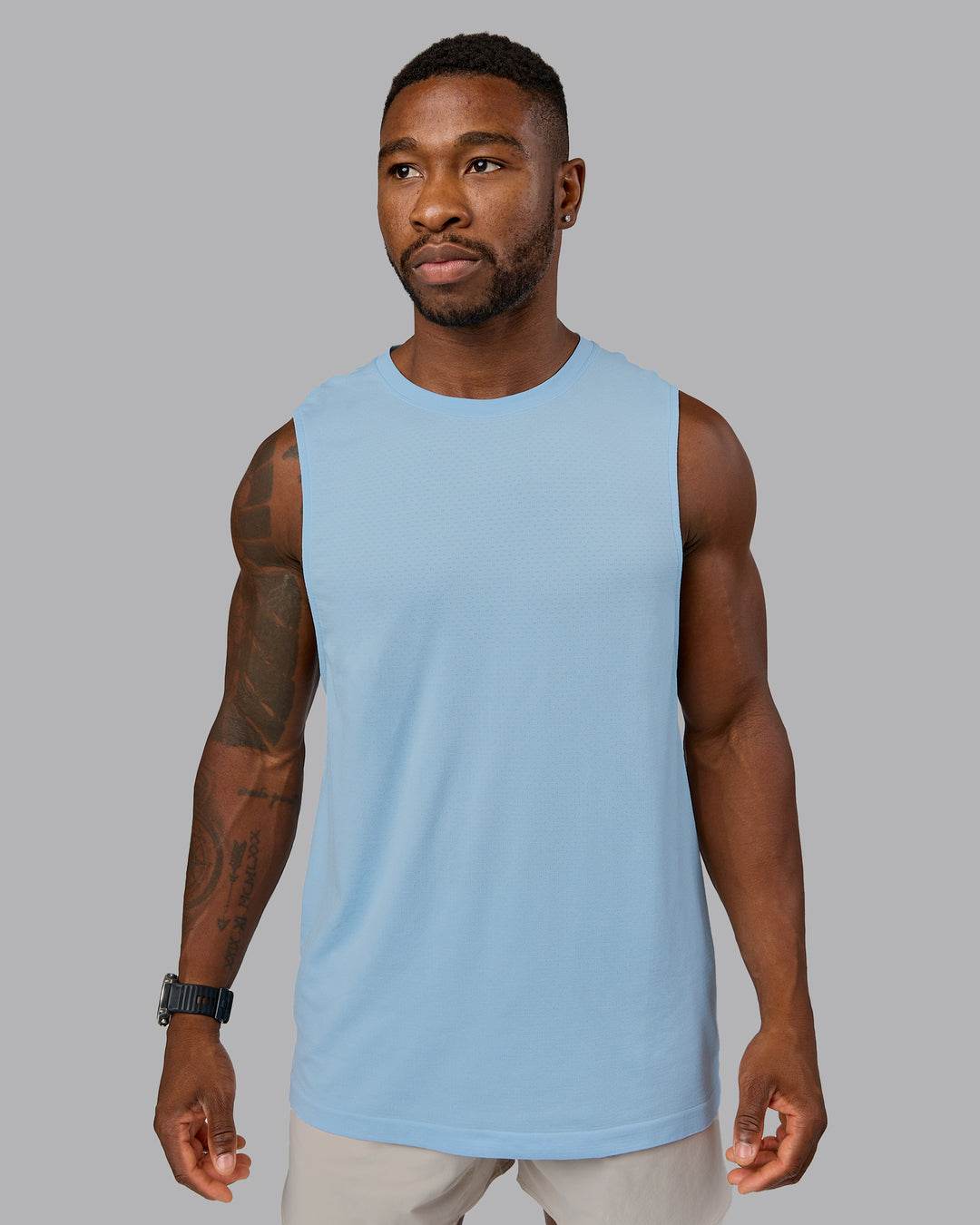 Man wearing AeroFLX+ Seamless Muscle Tank - Glacial Blue | Model:Sam | Size:L