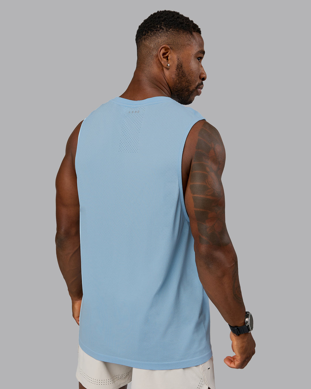 Man wearing AeroFLX+ Seamless Muscle Tank - Glacial Blue | Model:Sam | Size:L