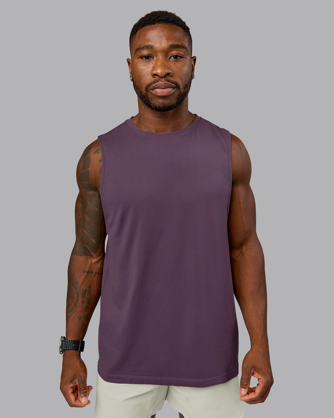 Model wearing AeroFLX+ Seamless Muscle Tank - Vintage Violet | Model:Sam | Size:L