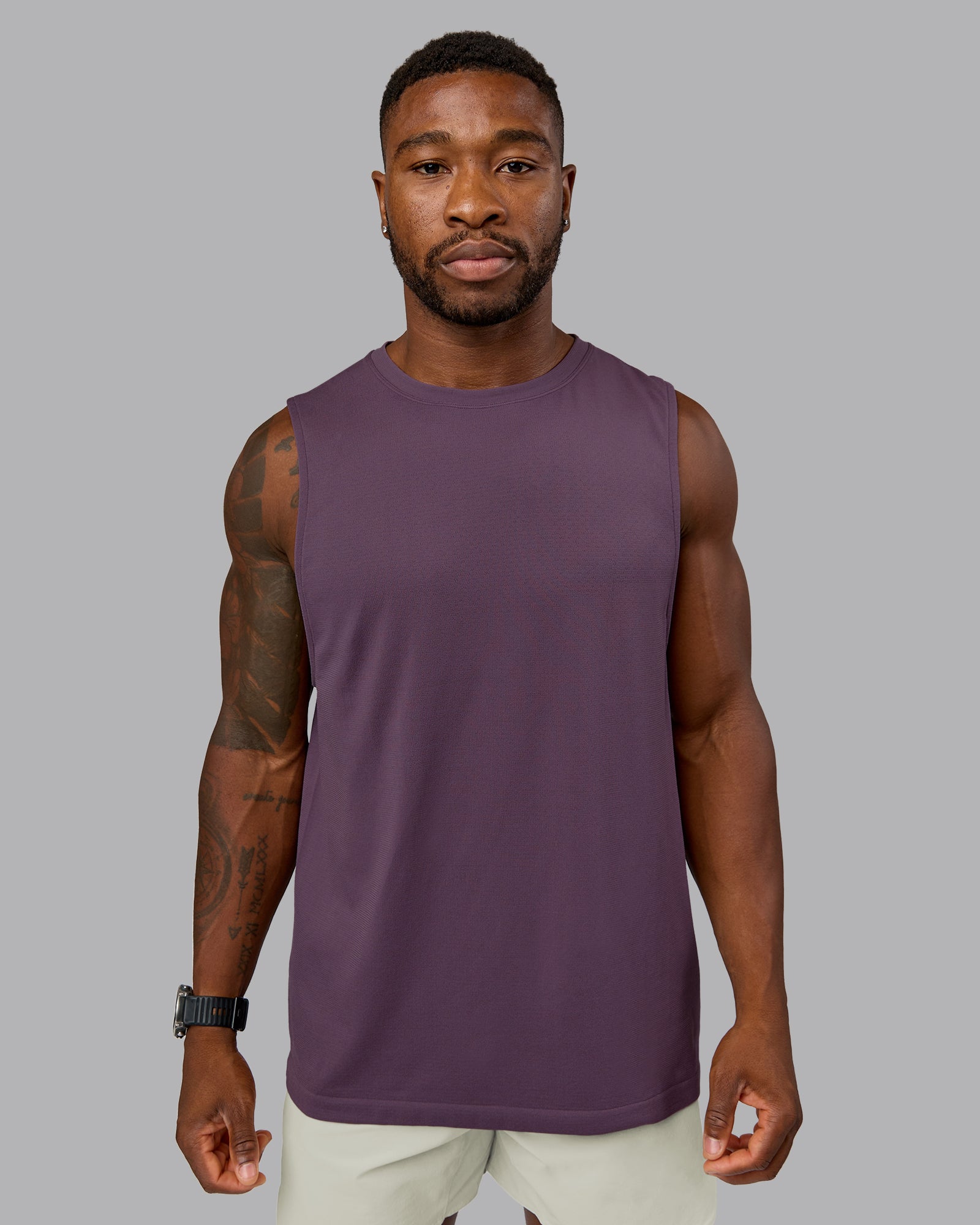 Model wearing AeroFLX+ Seamless Muscle Tank - Vintage Violet | Model:Sam | Size:L