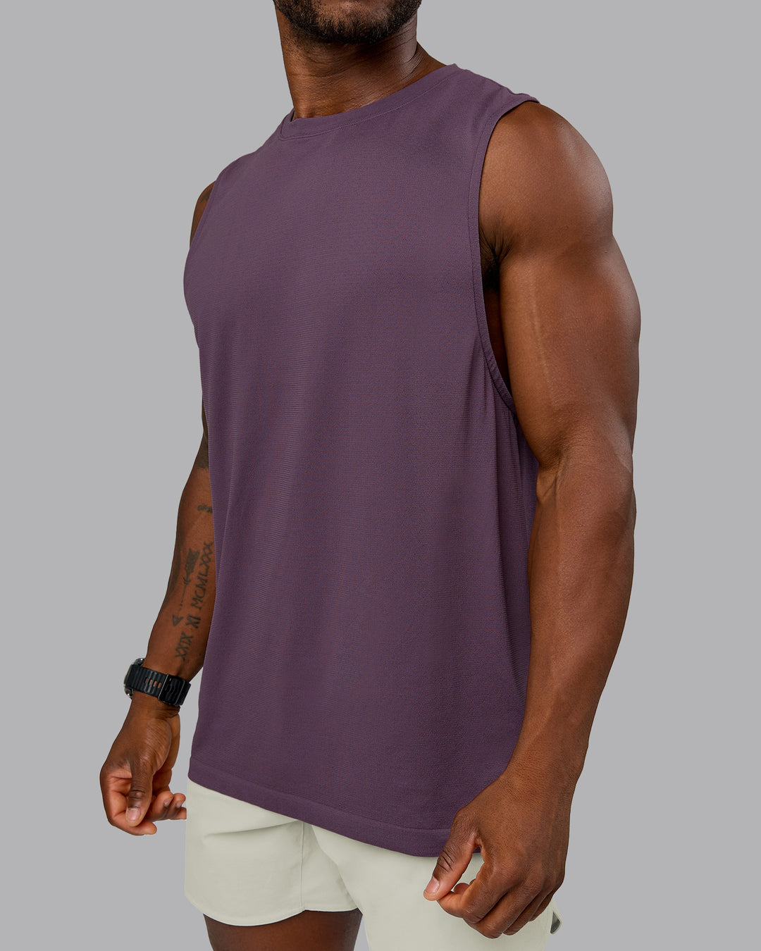Model wearing AeroFLX+ Seamless Muscle Tank - Vintage Violet | Model:Sam | Size:L