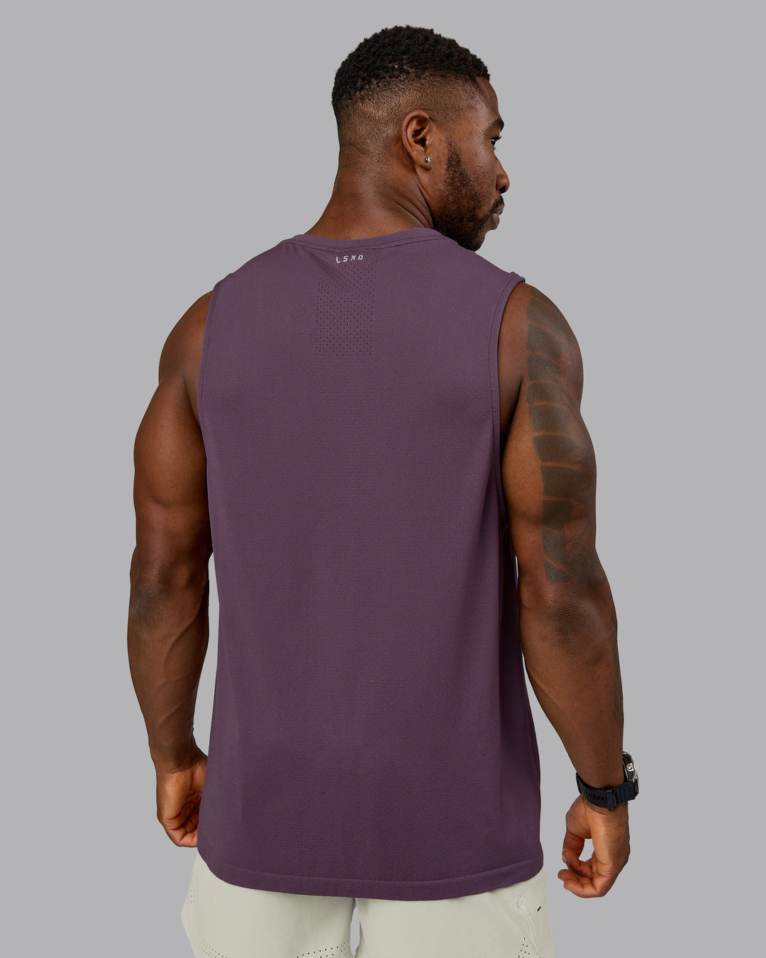 Model wearing AeroFLX+ Seamless Muscle Tank - Vintage Violet | Model:Sam | Size:L