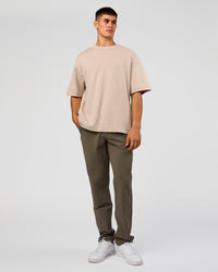 Man wearing AfterDark ZeroCrease Oversized Tee - Shale Beige | Model:Jackson | Size:L