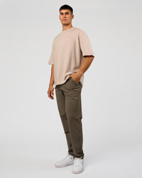 Man wearing AfterDark ZeroCrease Oversized Tee - Shale Beige | Model:Jackson | Size:L