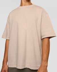 Man wearing AfterDark ZeroCrease Oversized Tee - Shale Beige | Model:Jackson | Size:L