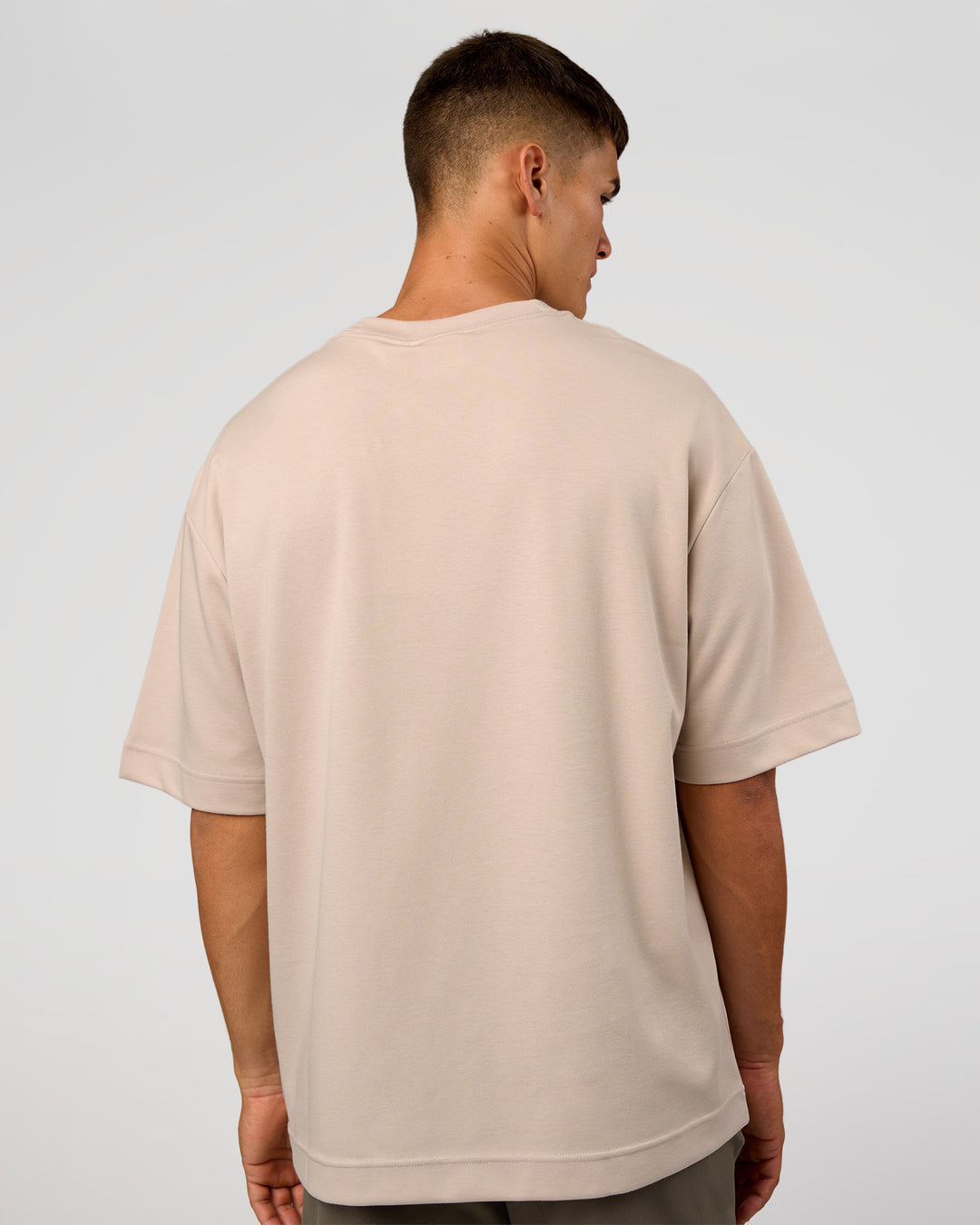 Man wearing AfterDark ZeroCrease Oversized Tee - Shale Beige | Model:Jackson | Size:L
