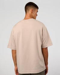 Man wearing AfterDark ZeroCrease Oversized Tee - Shale Beige | Model:Jackson | Size:L