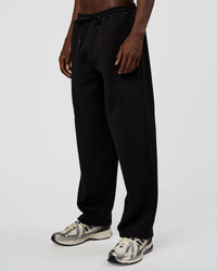 Man wearing AfterDark ZeroCrease Straight Leg Pant - Black | Model:Okello | Size:L