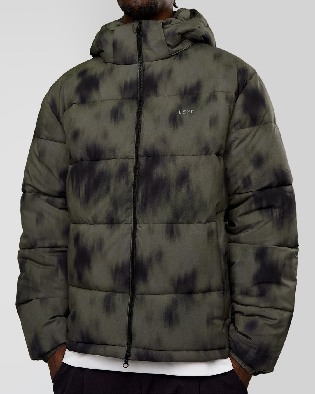 Man wearing Base Puffer Jacket - Camo Washed Walnut Grey | Model:Okello | Size:L
