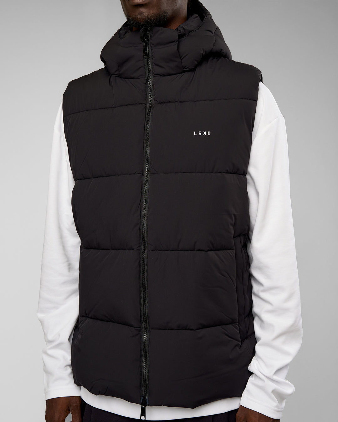 Man wearing Base Puffer Vest - Black | Model:Okello | Size:L