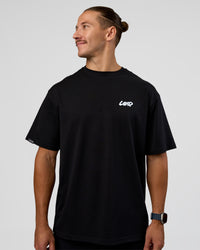 Man wearing Break Through FLXCotton Oversized Tee - Black-Open Air | Model:Jaiden | Size:L