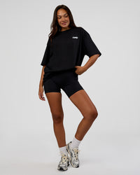 Woman wearing Break Through FLXCotton Oversized Tee - Black-Open Air | Model:Kirstyn | Size:L