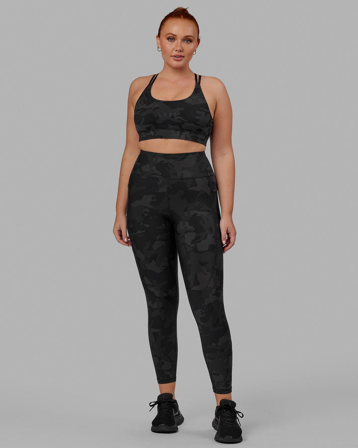 Woman wearing Bridge Sports Bra - Black Camo
