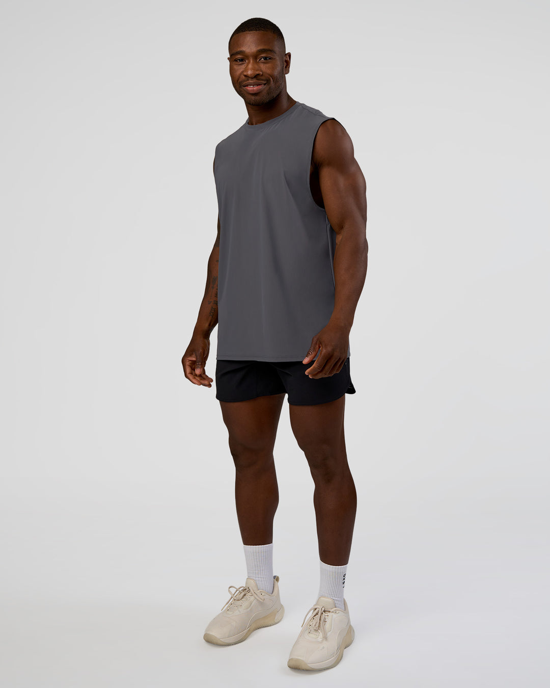 Man wearing Cadence MicroMotion Muscle Tank - Dark Storm | Model:Sam | Size:L