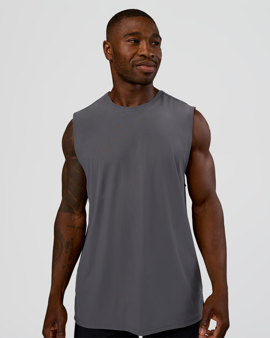 Man wearing Cadence MicroMotion Muscle Tank - Dark Storm | Model:Sam | Size:L