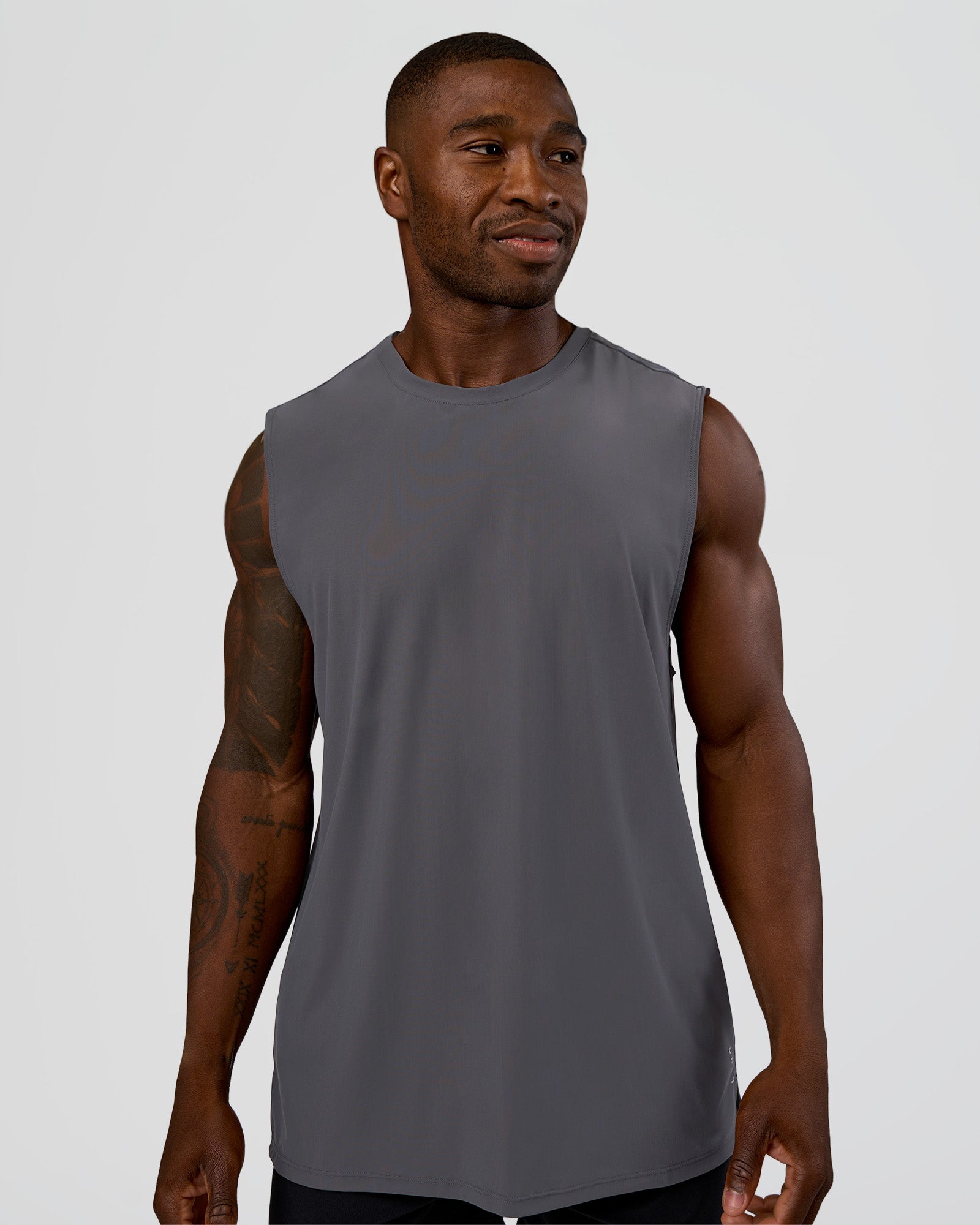 Man wearing Cadence MicroMotion Muscle Tank - Dark Storm | Model:Sam | Size:L