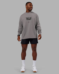 Man wearing Chrome Washed Heavyweight Oversized Long Sleeve Tee - Circular Grey-Black | Model:Sam | Size:L
