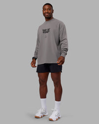 Man wearing Chrome Washed Heavyweight Oversized Long Sleeve Tee - Circular Grey-Black | Model:Sam | Size:L