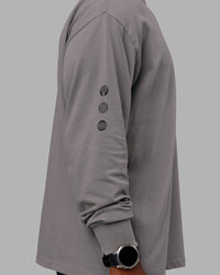 Man wearing Chrome Washed Heavyweight Oversized Long Sleeve Tee - Circular Grey-Black | Model:Sam | Size:L
