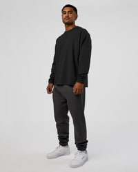 Man wearing Classic Heavyweight FLXCotton Oversized Long Sleeve Tee - Washed Black-Black | Model:Xav | Size:L