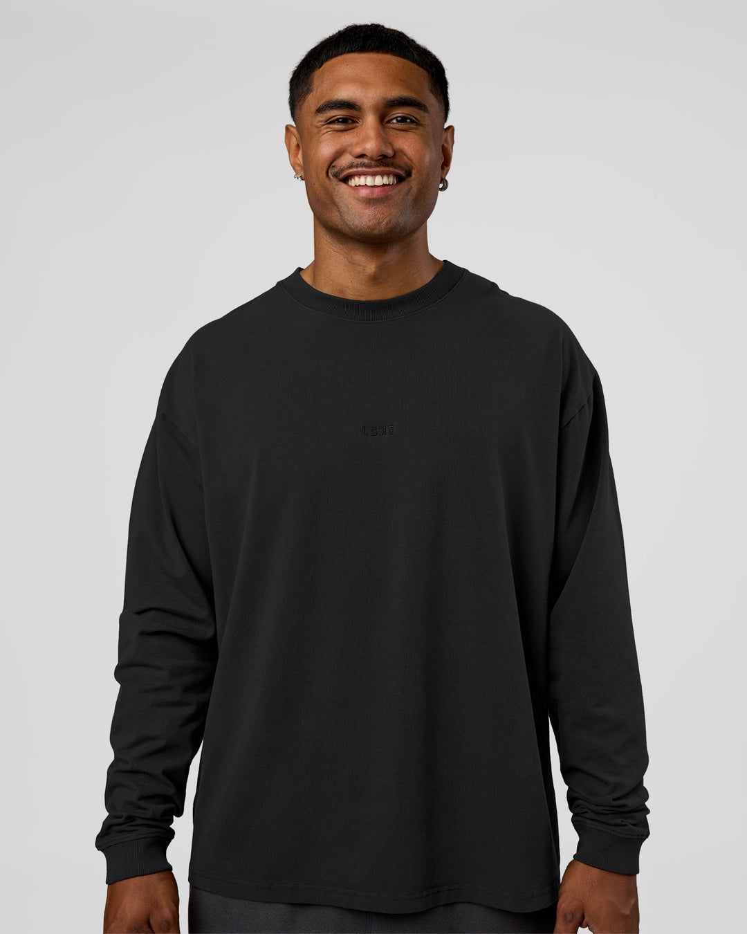 Man wearing Classic Heavyweight FLXCotton Oversized Long Sleeve Tee - Washed Black-Black | Model:Xav | Size:L