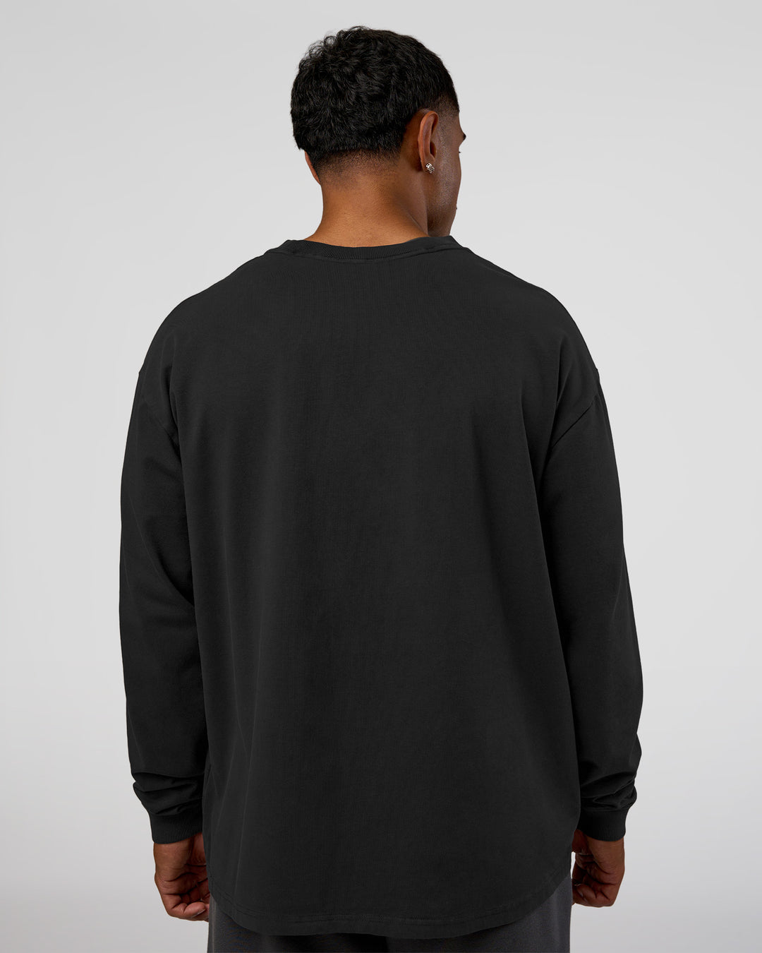Man wearing Classic Heavyweight FLXCotton Oversized Long Sleeve Tee - Washed Black-Black | Model:Xav | Size:L
