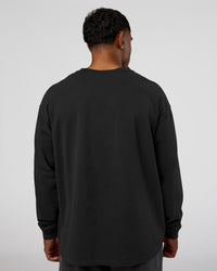 Man wearing Classic Heavyweight FLXCotton Oversized Long Sleeve Tee - Washed Black-Black | Model:Xav | Size:L