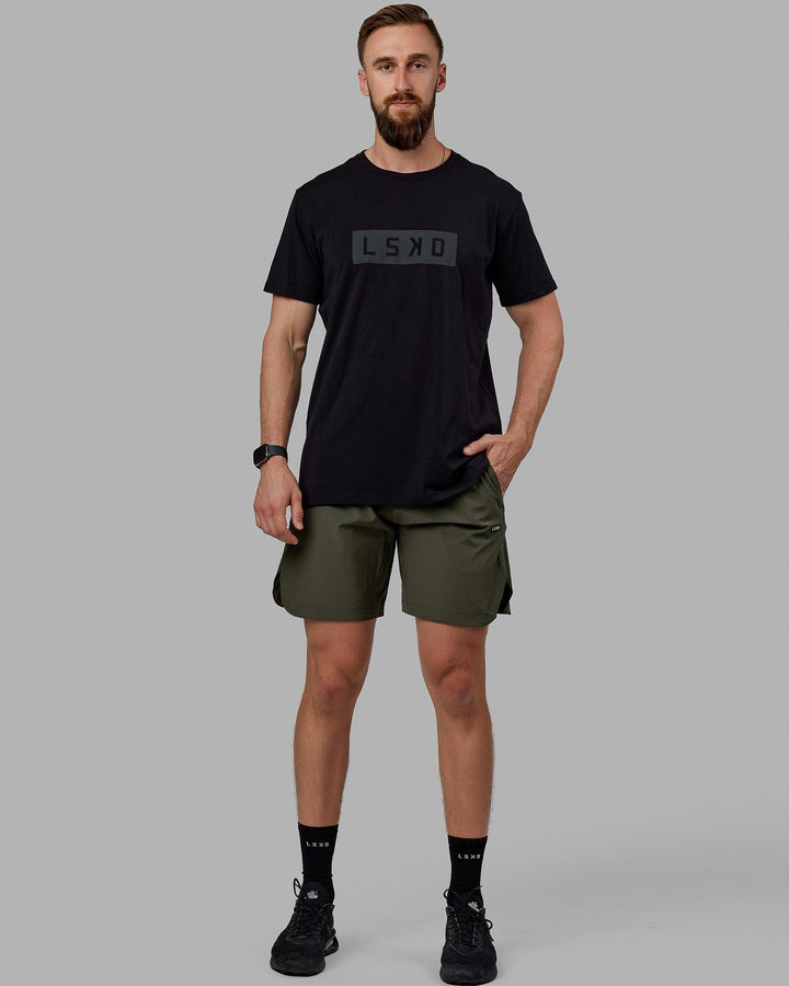 Man wearing Competition 8" Performance Short - Forest Night