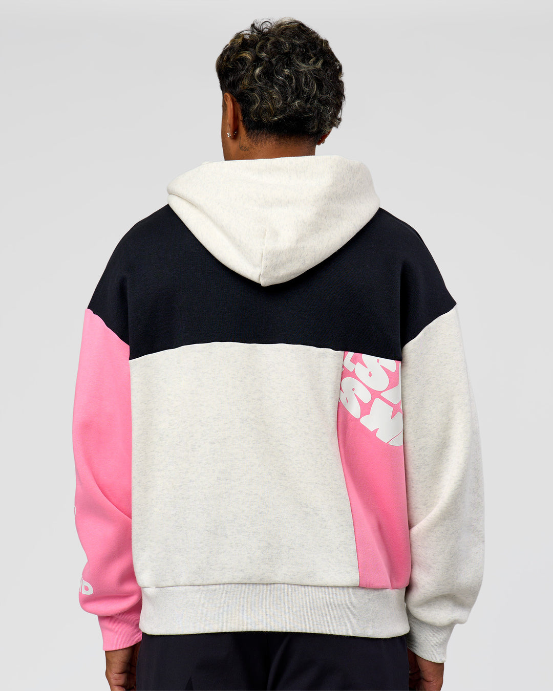 Man wearing Deconstructed Fleece Hoodie - Caviar-Candy Pink-Grey Marl | Model:Xav | Size:L