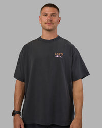 Man wearing Digital World Heavyweight Oversized Tee - Washed Black | Model:Nikola | Size:L