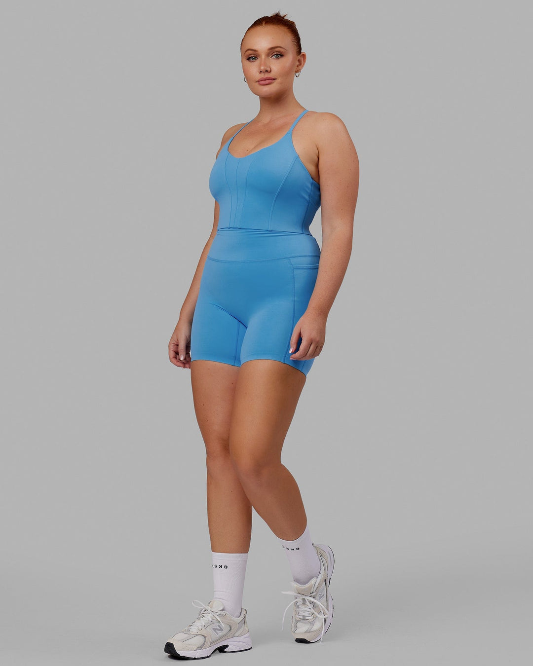 Woman wearing Elixir Mid Short Tight with Pockets - Azure Blue