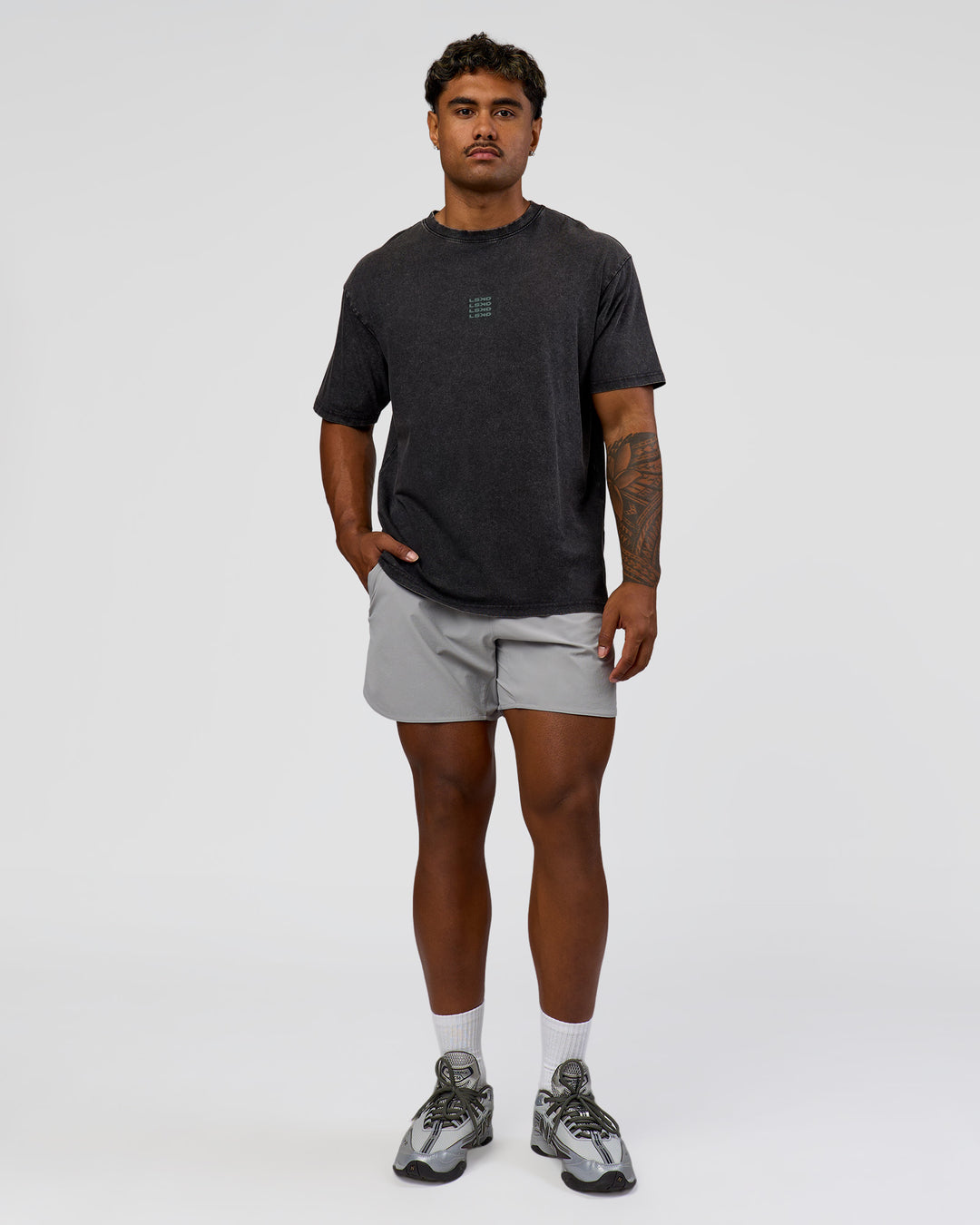 Man wearing Everyday Elevation FLXCotton Oversized Tee - Black Washed-Carbon Green | Model:Xav | Size:L
