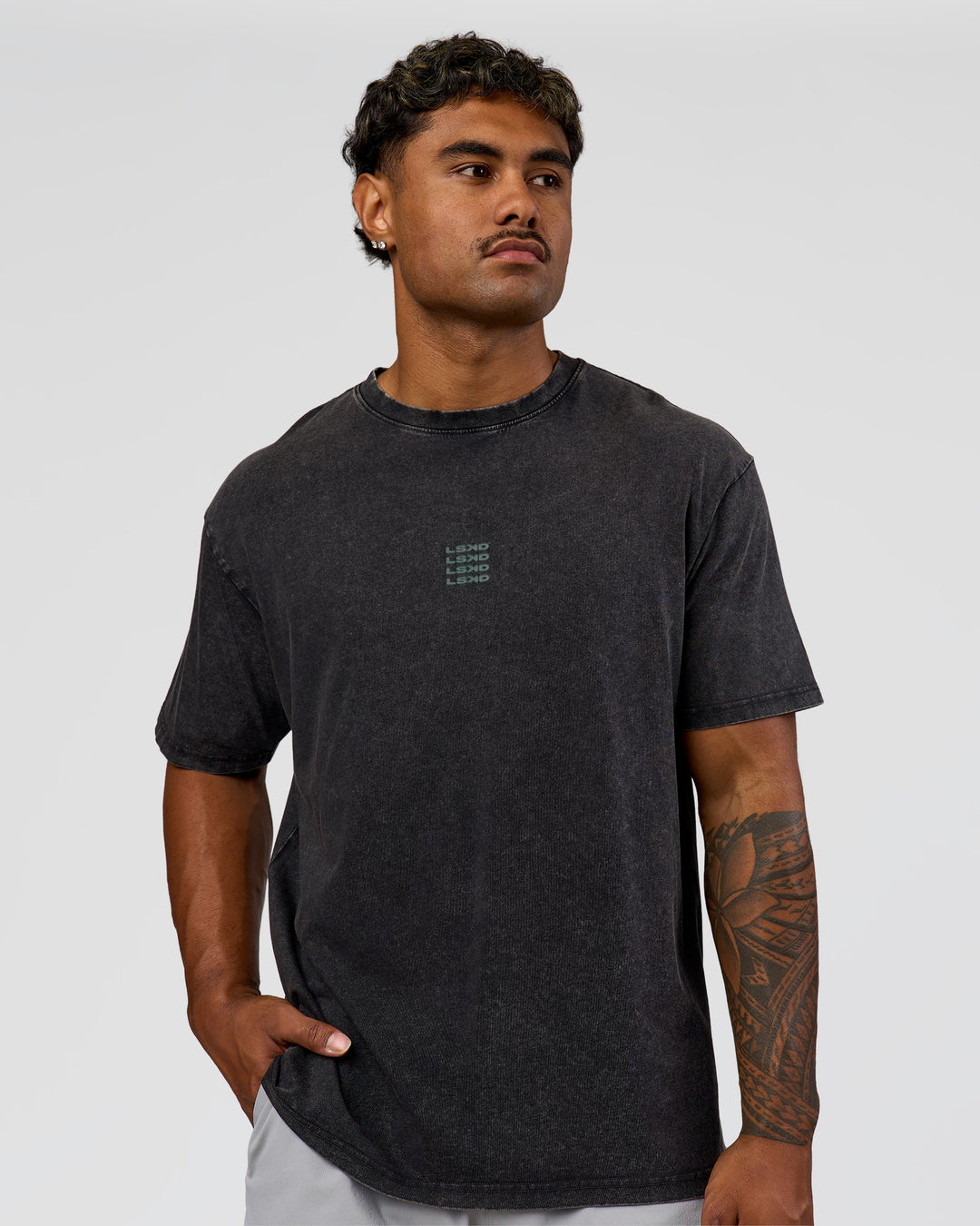 Man wearing Everyday Elevation FLXCotton Oversized Tee - Black Washed-Carbon Green | Model:Xav | Size:L
