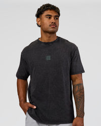 Man wearing Everyday Elevation FLXCotton Oversized Tee - Black Washed-Carbon Green | Model:Xav | Size:L