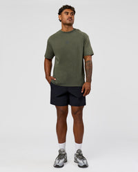 Man wearing Everyday Elevation FLXCotton Oversized Tee - Carbon Green Washed -White | Model:Xav | Size:L