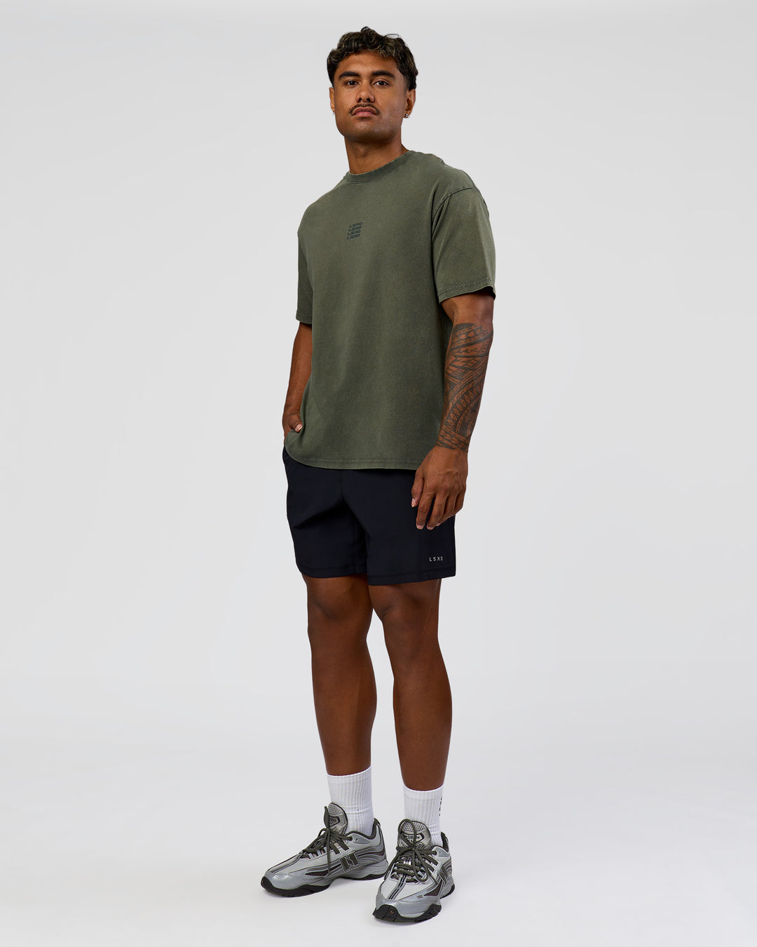 Man wearing Everyday Elevation FLXCotton Oversized Tee - Carbon Green Washed -White | Model:Xav | Size:L