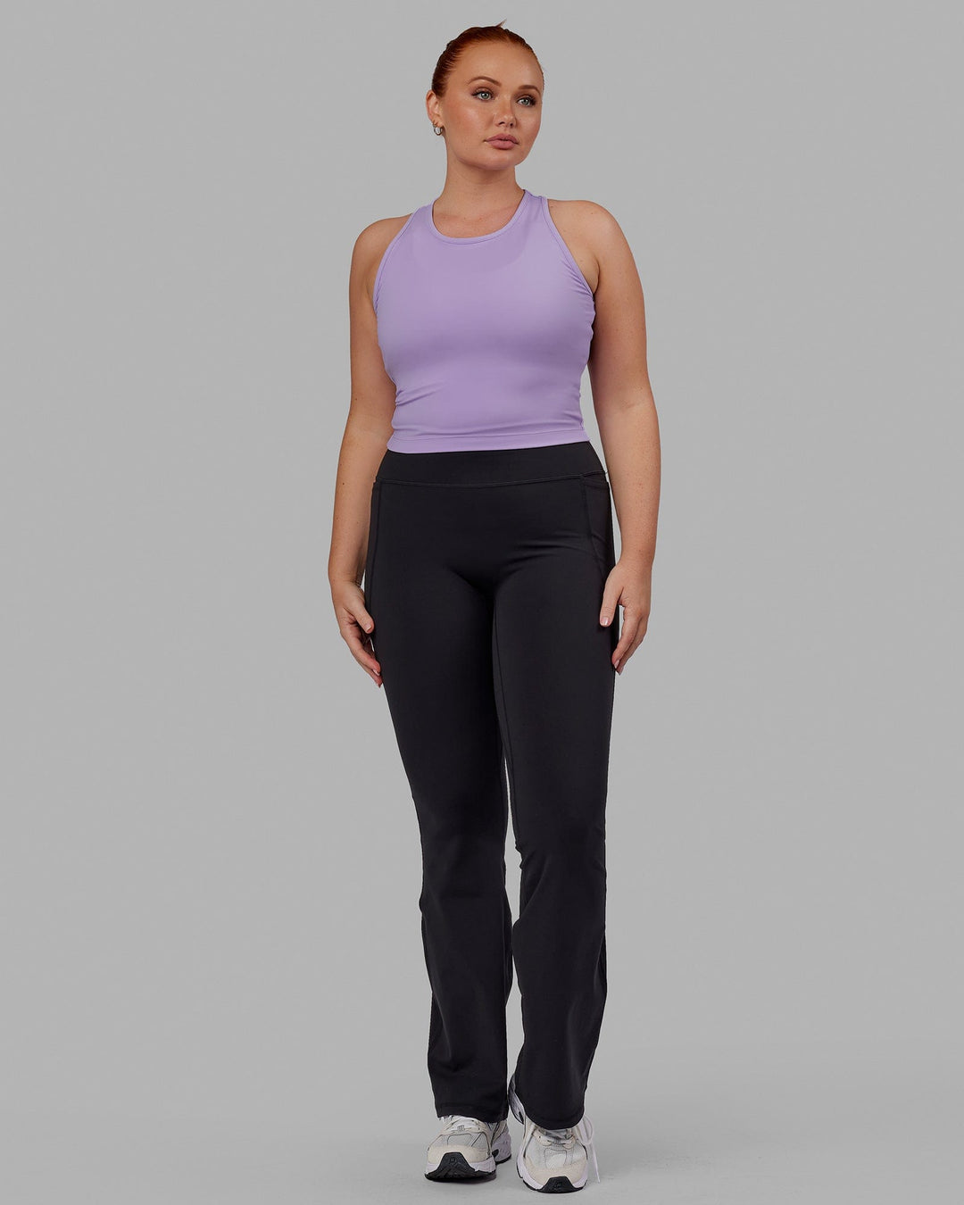 Woman wearing Fusion Ultra High-Rise Flared Legging Pockets - Black | Model:Brooke | Size:L