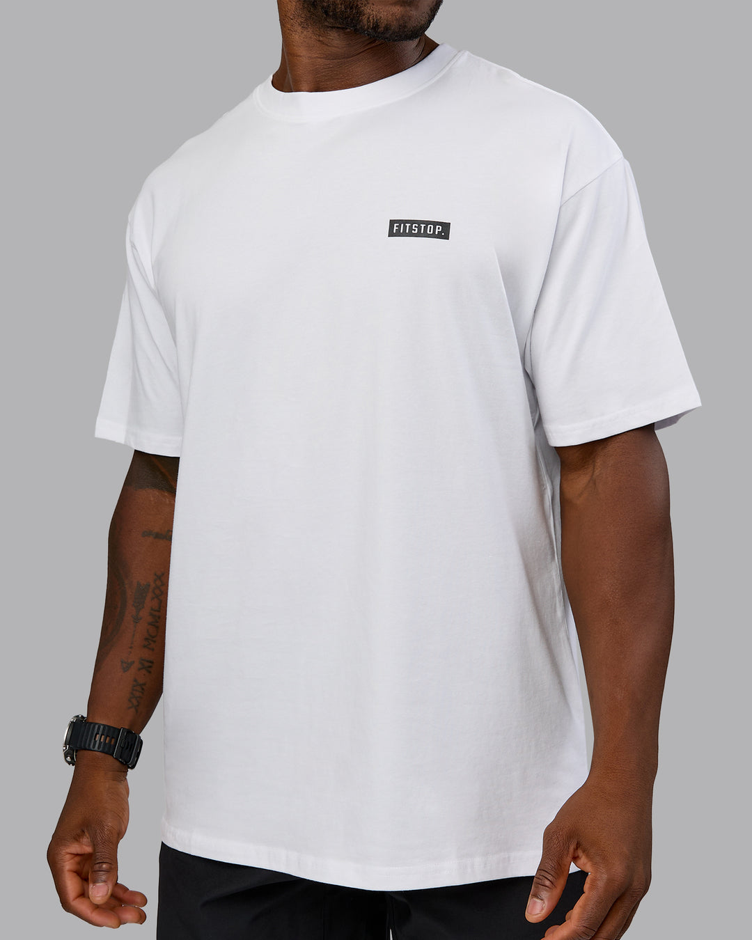 Man wearing Fitstop Embrace the Sweat FLXCotton Oversized Tee in White-Black | Size:L