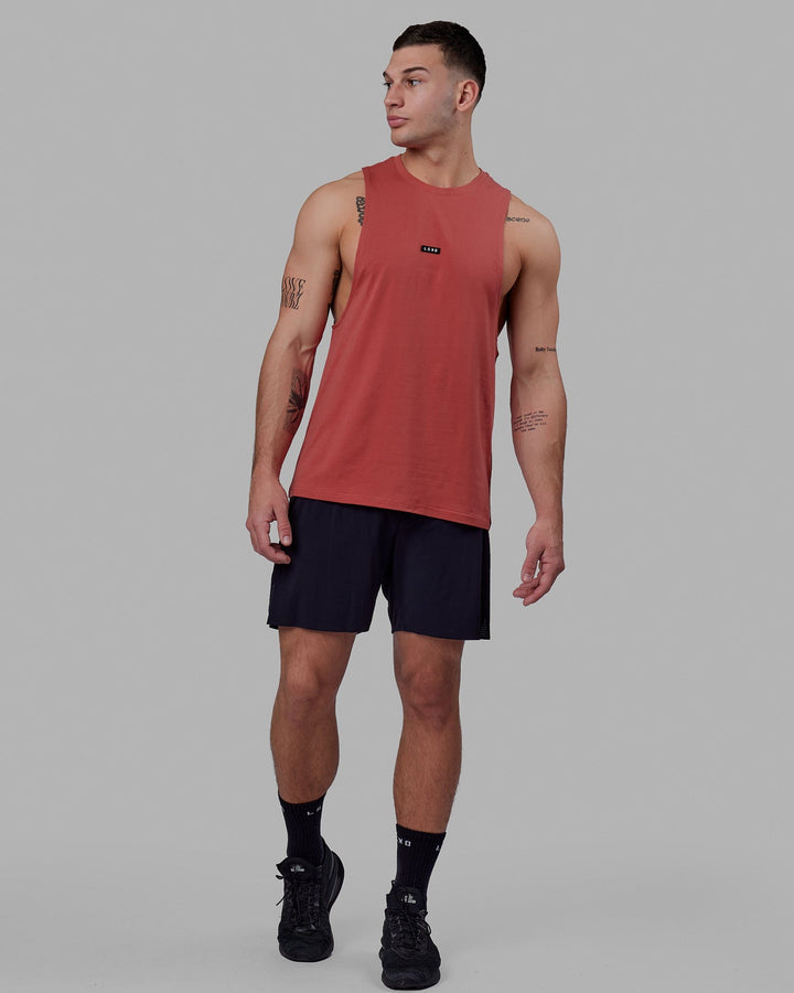 Man wearing Fundamental FLXCotton Drop Arm Tank - Mineral Red