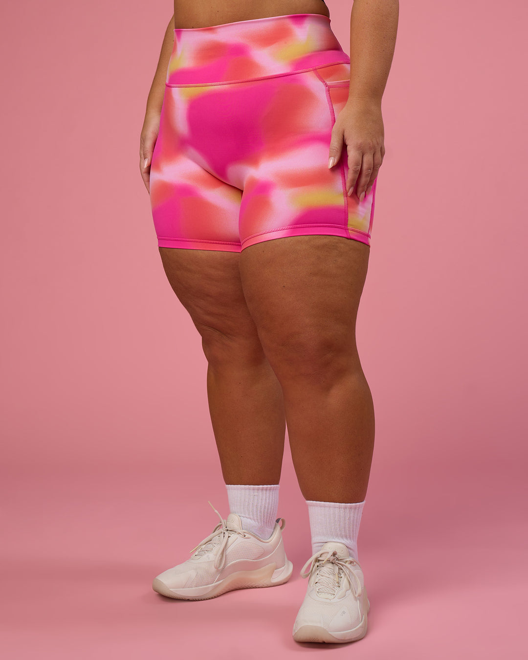 Woman wearing Fusion Ultra High-Rise 6&quot; Short Pockets - Pink Glow Print | Model:Bianca | Size:L
