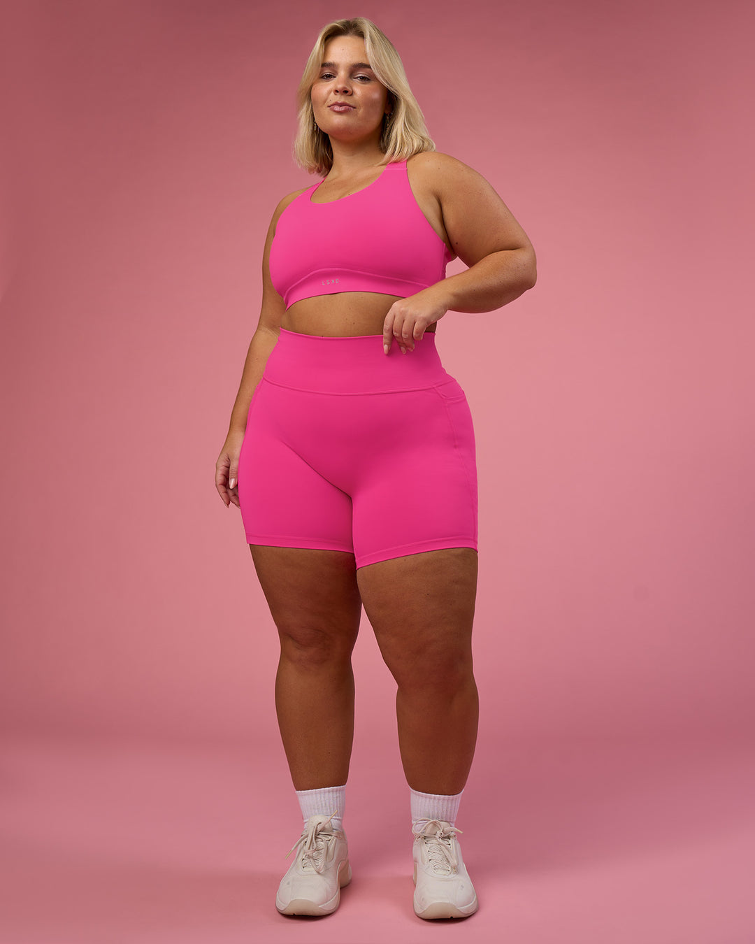 Woman wearing Fusion Ultra High-Rise 6&quot; Short Pockets - Ultra Pink | Model:Bianca | Size:L