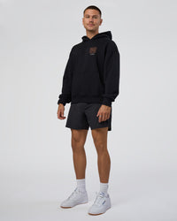 Man wearing GTC CVC Fleece Unisex Oversized Hoodie - Black-Cantaloupe | Model:Nikola | Size:L